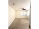 This bedroom features neutral carpet, a ceiling fan and two windows with blinds at 5644 Samter Ct, Tampa, FL 33611
