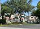View of Leila Avenue Villas community, showcasing the entrance sign and residences with manicured greenery at 5644 Samter Ct, Tampa, FL 33611
