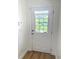 Bright foyer with a white door featuring a window and a storm door at 5644 Samter Ct, Tampa, FL 33611