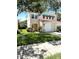 Charming two-story home features a terracotta roof, green awnings, and a well-maintained lawn at 5644 Samter Ct, Tampa, FL 33611