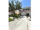 Townhome with green lawn, light tan stucco, white trim, single-car garage, and manicured landscaping at 5644 Samter Ct, Tampa, FL 33611
