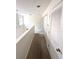 Hallway with carpet and two white doors plus a chandelier fixture near the window at 5644 Samter Ct, Tampa, FL 33611
