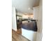 Bright kitchen with white cabinets, black countertops, stainless steel appliances, and laminate flooring at 5644 Samter Ct, Tampa, FL 33611
