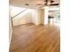 Spacious living room with wood laminate flooring, a staircase, and views of the kitchen at 5644 Samter Ct, Tampa, FL 33611