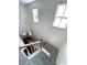 Staircase with carpet and two windows and view to the entryway door at 5644 Samter Ct, Tampa, FL 33611
