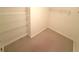 A carpeted walk-in closet has wire shelving units for optimal storage at 5644 Samter Ct, Tampa, FL 33611