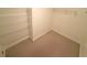 A carpeted walk-in closet has wire shelving units for optimal storage at 5644 Samter Ct, Tampa, FL 33611