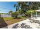 Spacious backyard featuring a white fence, lush grass, garden and a decorative rock border at 6334 22Nd N Ave, St Petersburg, FL 33710