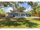 Expansive backyard with lush grass, mature trees, and a patio perfect for outdoor enjoyment at 6334 22Nd N Ave, St Petersburg, FL 33710