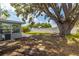 Backyard featuring mature trees, lush landscaping, and stone walkway at 6334 22Nd N Ave, St Petersburg, FL 33710