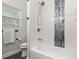 Clean bathroom showcasing a bathtub with shower, new fixtures, and a designer accent tile at 6334 22Nd N Ave, St Petersburg, FL 33710
