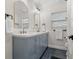 Stylish bathroom featuring dual sinks, modern fixtures, and updated gray cabinets with black hardware at 6334 22Nd N Ave, St Petersburg, FL 33710