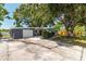 Charming single Gathering home featuring a gray accent wall, clean white garage door and long concrete driveway at 6334 22Nd N Ave, St Petersburg, FL 33710