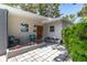Charming home entrance featuring a cozy seating area and lush landscaping leading to the front door at 6334 22Nd N Ave, St Petersburg, FL 33710