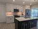 Modern kitchen with white cabinets, stainless steel appliances, and a stylish island with seating at 6334 22Nd N Ave, St Petersburg, FL 33710