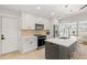 Well-lit kitchen with white cabinets, modern appliances, and eat-in island at 6334 22Nd N Ave, St Petersburg, FL 33710