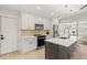 Stylish kitchen featuring an island, white cabinets, stainless appliances, and elegant pendant lighting at 6334 22Nd N Ave, St Petersburg, FL 33710