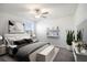 Spacious bedroom featuring a ceiling fan, a window with blinds, decorative shelving, and a queen bed at 6347 Ten Acre Ct, Zephyrhills, FL 33541