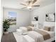 Bright bedroom with two beds, a window with blinds, light colored walls, and bench seats at 6347 Ten Acre Ct, Zephyrhills, FL 33541