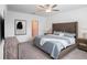 Comfortable bedroom featuring a plush bed with stylish headboard and matching wood nightstands at 6347 Ten Acre Ct, Zephyrhills, FL 33541