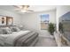 Comfortable bedroom with neutral decor, soft lighting from ceiling fan, and window views, enhancing the cozy ambiance at 6347 Ten Acre Ct, Zephyrhills, FL 33541