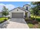 Charming two-story home featuring a spacious garage and well-maintained landscaping at 6347 Ten Acre Ct, Zephyrhills, FL 33541