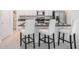 Modern kitchen with stainless steel appliances, island seating, and granite countertops at 6347 Ten Acre Ct, Zephyrhills, FL 33541
