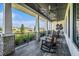 Relaxing porch with rocking chairs, ceiling fans, and stone accents at 6347 Ten Acre Ct, Zephyrhills, FL 33541