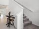 Hallway featuring a staircase, tiled floors, and an elegant decorative table at 6347 Ten Acre Ct, Zephyrhills, FL 33541