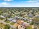 An aerial view of a neighborhood featuring single-Gathering homes, green trees, and city views in the distance at 6352 Canton S St, St Petersburg, FL 33712