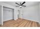 Neat bedroom featuring wood-look floors, a closet with doors removed, and an adjacent doorway at 6352 Canton S St, St Petersburg, FL 33712
