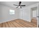 Inviting bedroom featuring wood-look floors, a closet, and an adjacent doorway, offering convenience and style at 6352 Canton S St, St Petersburg, FL 33712