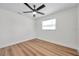 Bright bedroom features ceiling fan, wood-look floors, and a window for natural light at 6352 Canton S St, St Petersburg, FL 33712