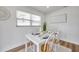 Inviting dining space with a white table, wooden chairs, and natural light streaming through the window at 6352 Canton S St, St Petersburg, FL 33712