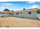 Exterior of the home features a back porch, manicured gravel yard, and a neutral paint scheme at 6352 Canton S St, St Petersburg, FL 33712