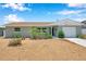 Charming single-story home featuring a manicured front yard with fresh gravel and bright green lawn at 6352 Canton S St, St Petersburg, FL 33712