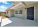 Covered front porch with a modern navy blue front door and freshly painted brick at 6352 Canton S St, St Petersburg, FL 33712