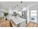 A bright, updated kitchen featuring stainless steel appliances, an island with seating and access to the outdoors at 6352 Canton S St, St Petersburg, FL 33712