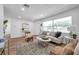 Inviting living room boasting natural light, wood-look flooring, and neutral color palette at 6352 Canton S St, St Petersburg, FL 33712