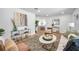 Comfortable living room featuring neutral walls and wood-look flooring and views to the kitchen at 6352 Canton S St, St Petersburg, FL 33712