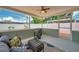 Cozy screened patio with wicker furniture, ceiling fan, and view of fenced backyard at 6352 Canton S St, St Petersburg, FL 33712