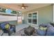 Comfortable covered patio with wicker seating and view of the spacious, fenced backyard at 6352 Canton S St, St Petersburg, FL 33712