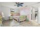 A bedroom featuring colorful decorations, a unique fan, and stylish decor at 6715 Ranchwood Loop, New Port Richey, FL 34653