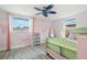 A bedroom featuring colorful decorations, a unique fan, and stylish decor at 6715 Ranchwood Loop, New Port Richey, FL 34653