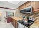 Well-lit kitchen featuring wooden countertops, mosaic backsplash, and stainless steel appliances at 6715 Ranchwood Loop, New Port Richey, FL 34653