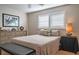 Well-lit bedroom with shuttered window, neutral decor, and dresser at 7941 58Th N Ave # 301, St Petersburg, FL 33709
