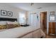 Cozy bedroom featuring an ensuite bathroom, shuttered windows, and decorative pillows and artwork at 7941 58Th N Ave # 301, St Petersburg, FL 33709