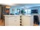 Bright and modern kitchen with white cabinets, spacious island, wine rack and open layout to the living area at 7941 58Th N Ave # 301, St Petersburg, FL 33709
