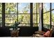 Bright sunroom/lanai featuring a wall of windows providing beautiful outdoor views and a charming seating area at 7941 58Th N Ave # 301, St Petersburg, FL 33709