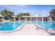 Large community pool area with lounging chairs and shade at 7941 58Th N Ave # 301, St Petersburg, FL 33709